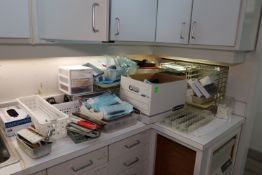 Contents of right side of tabletop including various dental instruments and other miscellaneous dent