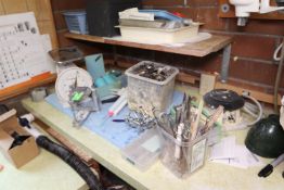 Contents of tabletop including Hansen scale, Wagner Work Balance, Mix Pack mixing caulk gun, and oth