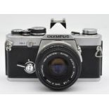 An Olympus OM-2 film camera with a Zuiko Auto-S f/1.8 50mm lens.