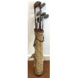 A collection of eleven vintage golf clubs and golf balls, including hickory shafted examples, makers