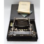 An early twentieth century Corona 3 portable typewriter featuring a distinctive three bank