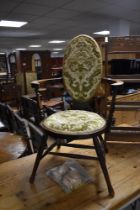 A Victorian mahogany armchair having overstuffed seats and back , with double turned stretchers
