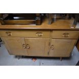 A Vintage Ercol sideboard having '2-1' formation on splay legs, width approx. 120cm