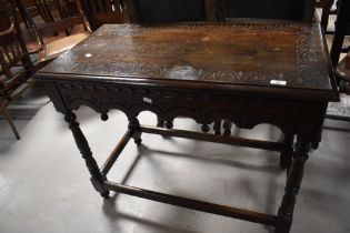 A Victorian oak side table having carved lunette decoration