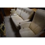 A vintage two piece lounge suite, possibly Ercol having wood frame and cream upholstery