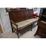 A George III oak settle having four fielded panes and cabriole style front legs