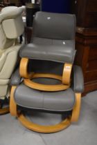 A modern easy chair in the stressless style, with similar footstool