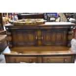 A mid stain Ercol court cupboard, width 123cm