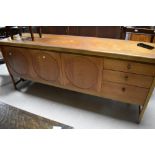 A vintage teak sideboard, Nathan 'circles' design, drop flap cocktail section to left, width central
