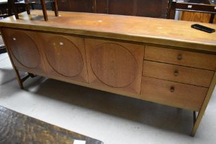A vintage teak sideboard, Nathan 'circles' design, drop flap cocktail section to left, width central