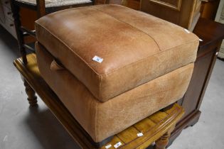 A modern soft leather ottoman footstool