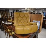 A vintage mustard/ochre vinyl armchair on chrome swivel frame