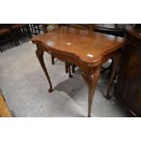 An early 20th Century walnut fold over card table, width approx. 76cm