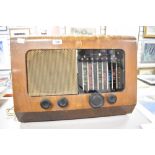 A vintage 1950's PYE walnut veneered radio, of typical form with glass tuner scale and metal speaker