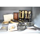 A mahogany vanity set to include two hand mirrors and two brushes, a pair of mahogany