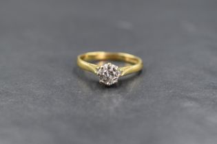 An 18ct gold diamond set solitaire ring, the round brilliant cut diamond measuring approximately 0.