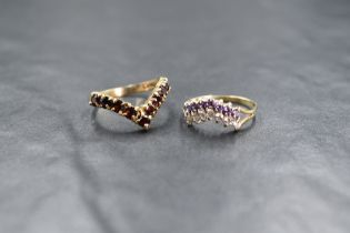 A 9ct gold cubic zirconia and purple paste set double wishbone ring, having split shoulders,