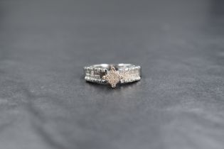 A 14ct white gold diamond set cluster ring, the central square cluster having sixteen pave set