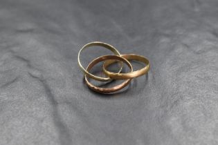 A 9ct gold three tone trinity ring, having interlocking yellow, rose and white gold bands, marked