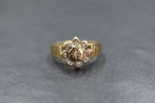 A 9ct gold diamond set cluster ring, the central diamond in an eight illusion diamond chip set