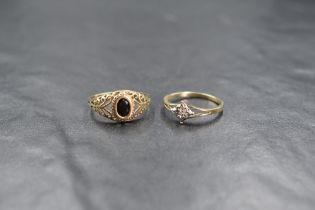 A 9ct gold sapphire set signet style ring, the oval cut sapphire in a bezel setting with pierced