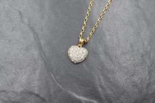 An 18ct gold diamond encrusted heart pendant having thirty five small pave set diamonds totalling