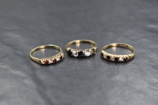 A 9ct gold sapphire and cubic zirconia set half eternity band, the four round cut sapphires