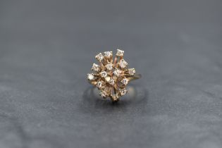 A 9ct gold modern diamond set cluster ring, the sixteen round brilliant cut diamonds in a modern
