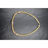 An 18ct gold diamond set Fope Gioielli necklace, the woven gold chain having three diamond set white