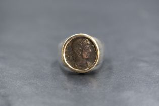 A silver and 14ct gold coin set signet ring, the imitation Roman coin in a yellow gold bezel setting