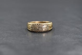 A 9ct gold diamond set band, the pave set diamond chips in three rows, marked 375, ring size O-P,