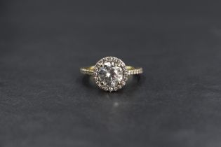 A yellow metal diamond halo ring having a central diamond approx 1.33ct within a diamond halo
