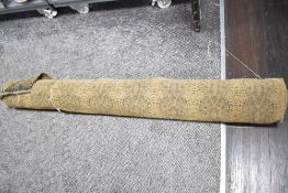 A large ream of woven wool blend jacquard fabric in camel colour with black snakeskin print