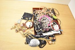 A collection of costume jewellery, including bangles, beaded jewellery, paste set pieces and drop