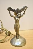 A 20th-century Art Deco-style patinated spelter table lamp base, featuring a female figure with