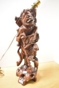 A tall 20th-century Chinese rootwood figural lamp base, most likely depicting the immortal Li