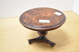 A small 20th-century brass inlaid burr wood pedestal table, possible apprentice piece, having a