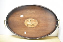 An Edwardian inlaid mahogany serving tray, of oval form, having a central inlaid marquetry design of