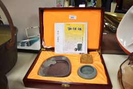 A modern Chinese Qingqu inkstone, carved from Songhua stone and sold along with a water bowl and
