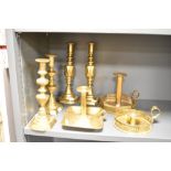 A large quantity of 19th to early 20th-century brass candle sticks, to include two 'Diamond