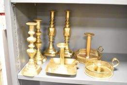 A large quantity of 19th to early 20th-century brass candle sticks, to include two 'Diamond