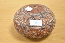 A 20th-century Peruvian Folk Art hand-carved gourd, depicting scenes of daily rural life amongst