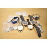 A collection of wristwatches and watch faces, including Garrard, Rotary, Zenith, Seiko and Fossil