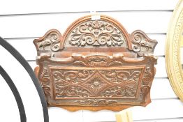 A 19th-century carved oak wall mounted letter holder, of floral and foliate decoration,
