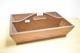 A 20th century oak cutlery tray, with two oblong divisions and central pierced carrying handle