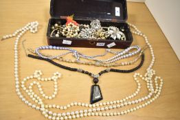 A small assortment of costume jewellery, including faux pearls, statement pieces and brooches, in