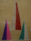 A pair of framed multicoloured pennant flags, mounted to hessian fabric and within interesting cut
