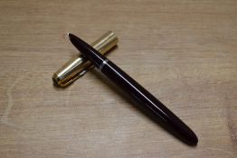 A Parker 51 aerometric fill fountain pen in Burgundy with Gold Fill converging line cap. Circa 1950