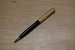 A boxed Parker 51 clutch pencil in Black with Rolled Gold converging line cap. Circa 1956