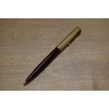 A Parker 51 ballpoint pen in Burgundy with Rolled Gold converging lines cap. Circa 1955